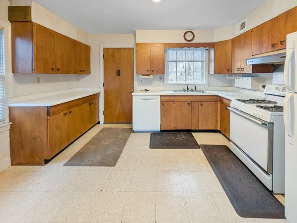 a kitchen with a stove microwave and sink