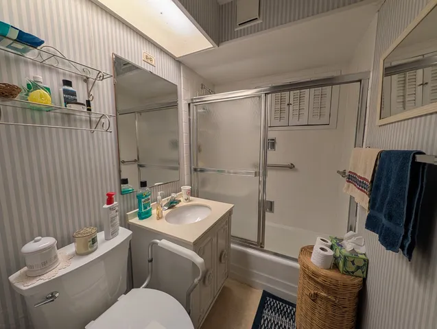 a bathroom with a toilet and a shower
