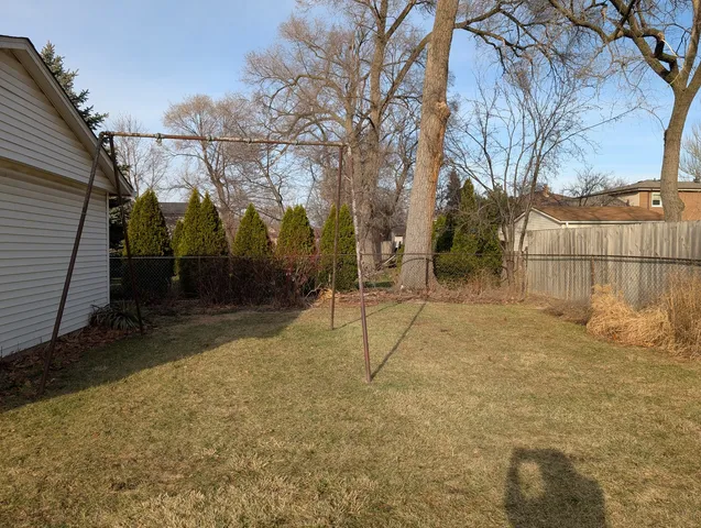 a view of a house with a yard and garage