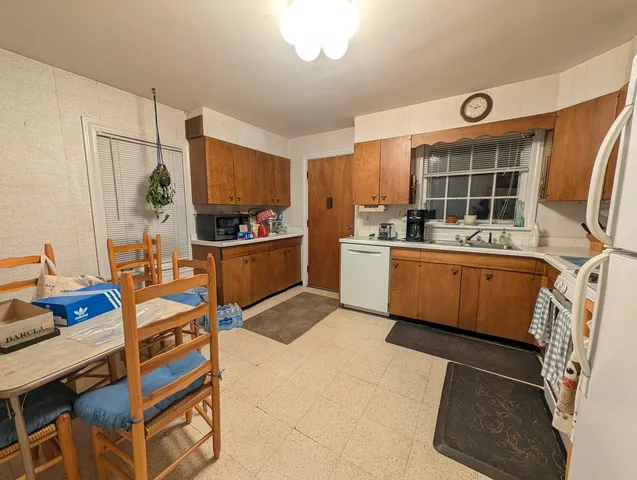 a kitchen that has a sink and a stove in it