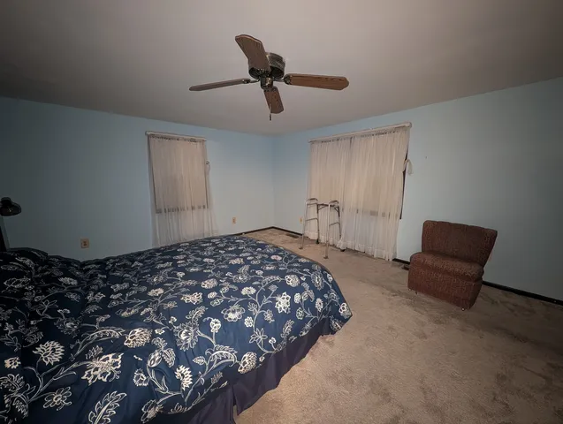 a bedroom with bed and a chandelier