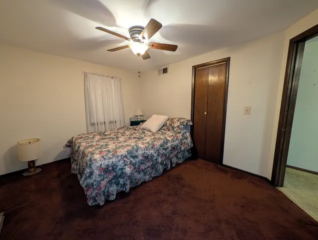 a bedroom with a bed and a dresser