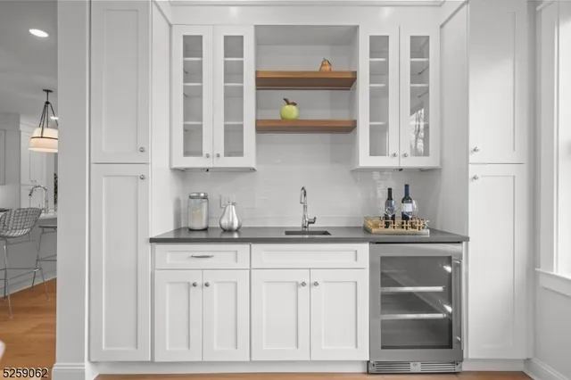 a kitchen with granite countertop white cabinets and window