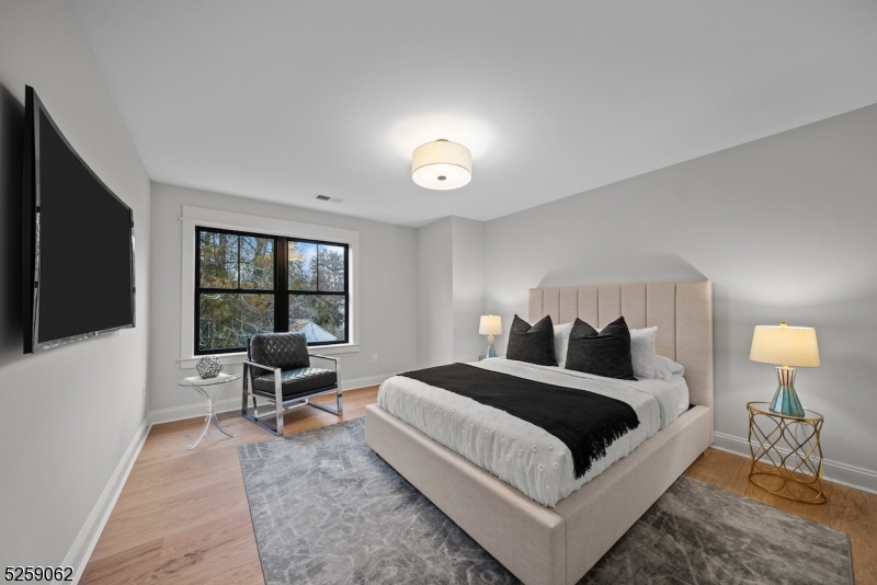 147 Center Avenue, Unit 20 Old Tappan, NJ 07675 - Photo 34 of 48 a spacious bedroom with a bed and large window