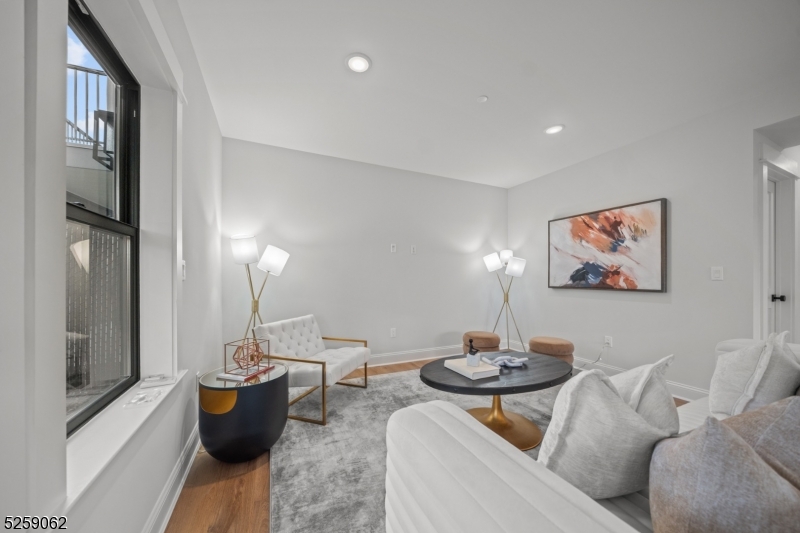 147 Center Avenue, Unit 20 Old Tappan, NJ 07675 - Photo 40 of 48 a living room with furniture a lamp and a potted plant