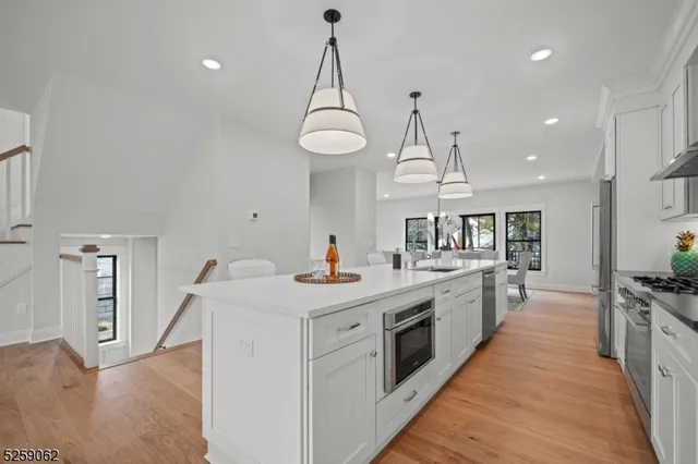 a kitchen with stove a sink and refrigerator