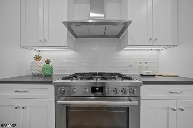 a stove top oven sitting inside of a kitchen