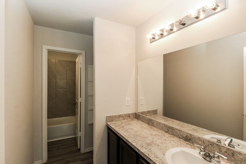 2744 Madison Court Willis, TX 77378 - Photo 14 of 16 a bathroom with a granite countertop sink and vanity