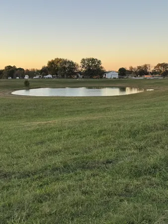 a view of a lake with houses in the back