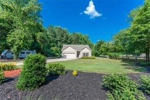 2660 Dr Bramblett Road Cumming, GA 30028 - Photo 1 of 1 a view of a garden with a table and a fire pit
