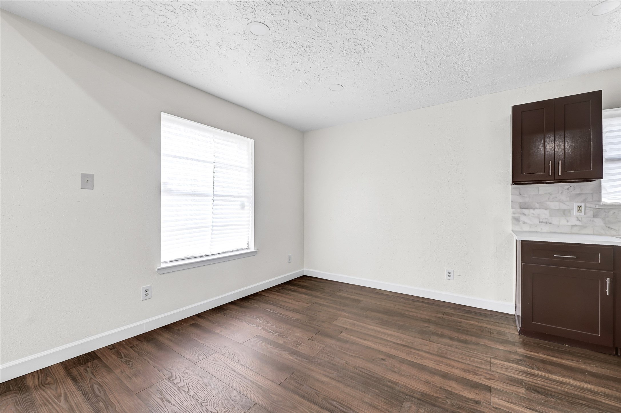 15907 Timber Valley Drive Houston, TX 77070 - Photo 11 of 27 an empty room with wooden floor and window