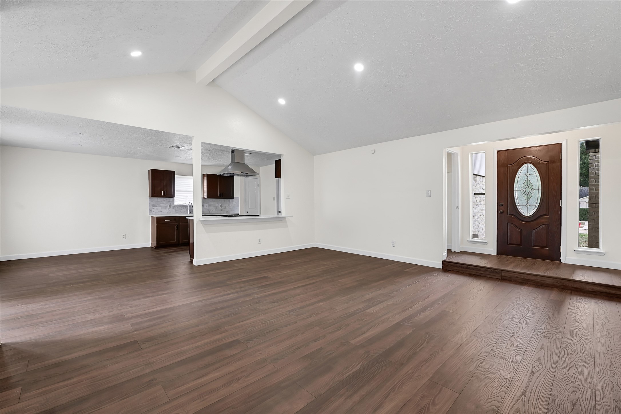 15907 Timber Valley Drive Houston, TX 77070 - Photo 8 of 27 an empty room with wooden floor and fireplace
