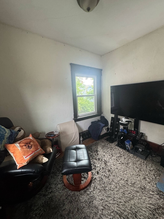 104 Maple Street Gardner, MA 01440 - Photo 12 of 15 a living room with furniture a flat screen tv and a window