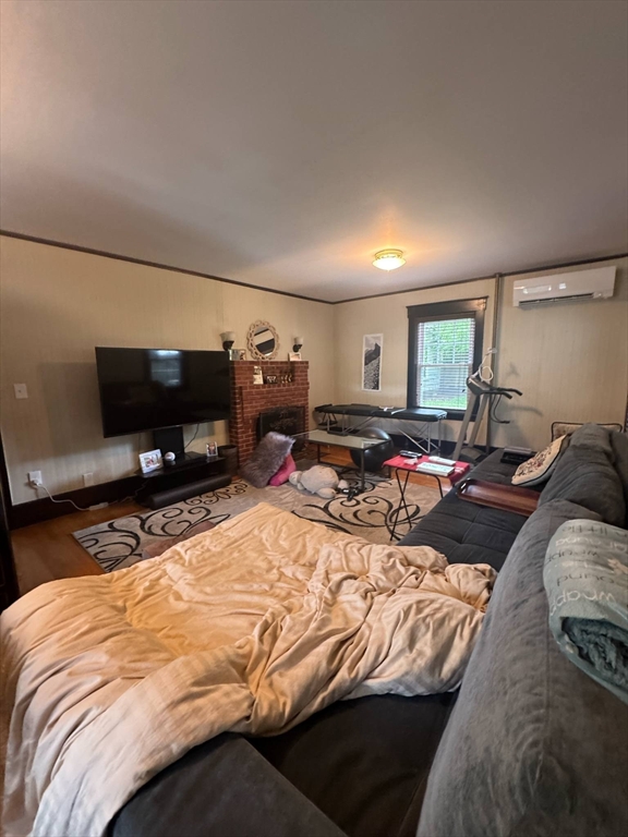 104 Maple Street Gardner, MA 01440 - Photo 6 of 15 a bed sitting in a bedroom and tv