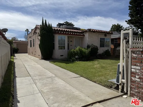 a view of a house with a garden and plants