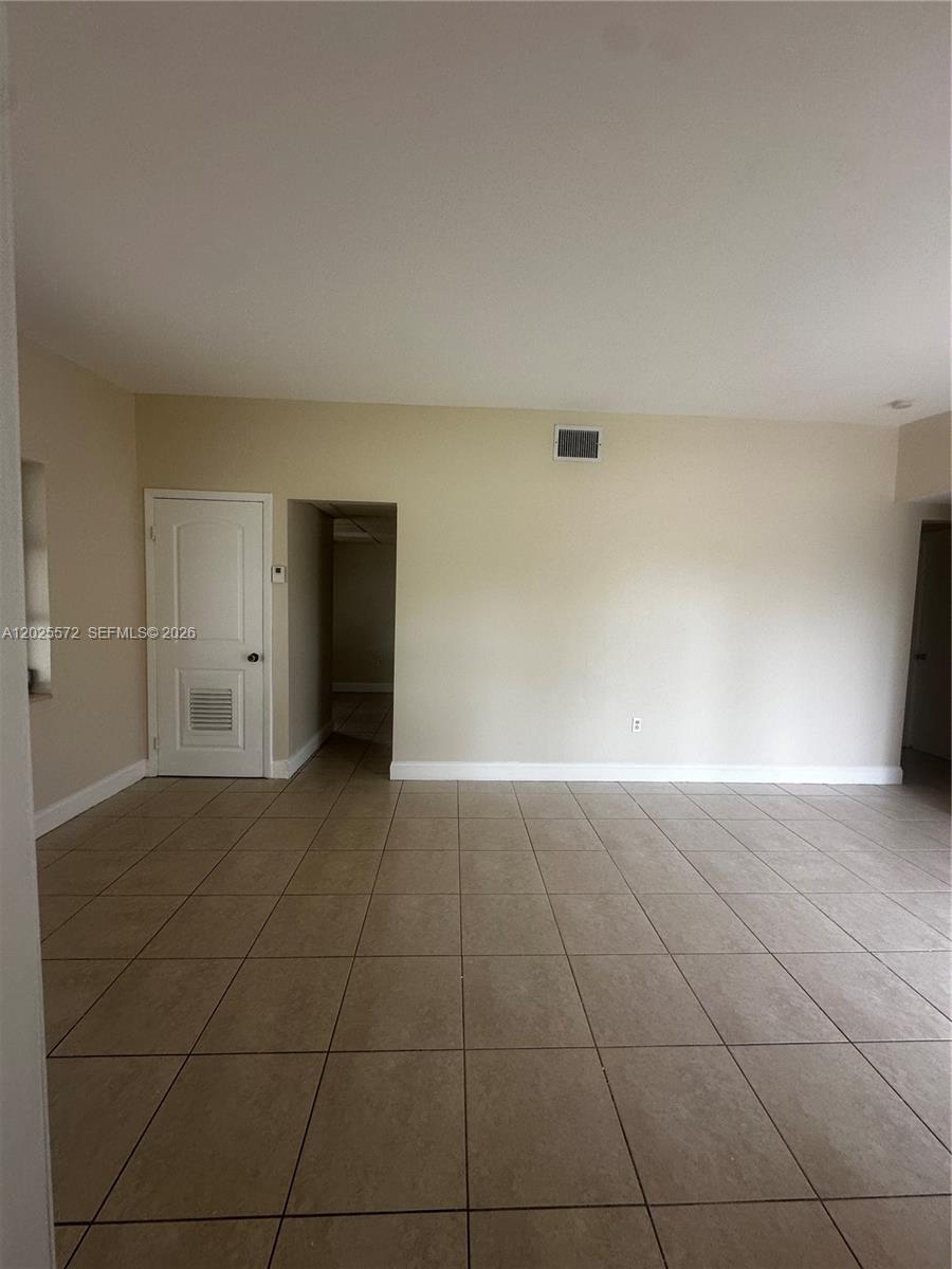 14475 Southwest 288th Street Homestead, FL 33033 - Photo 14 of 26 a view of an empty room with a kitchen