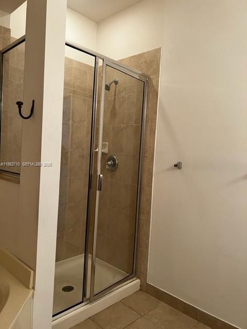 608 Northeast 33rd Terrace, Unit 608 Homestead, FL 33033 - Photo 11 of 35 a bathroom with a glass shower door
