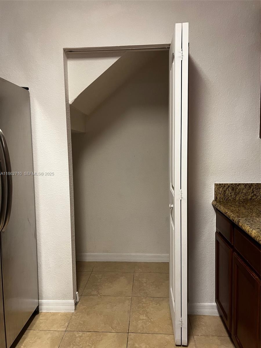 608 Northeast 33rd Terrace, Unit 608 Homestead, FL 33033 - Photo 23 of 35 a view of a kitchen from the hallway