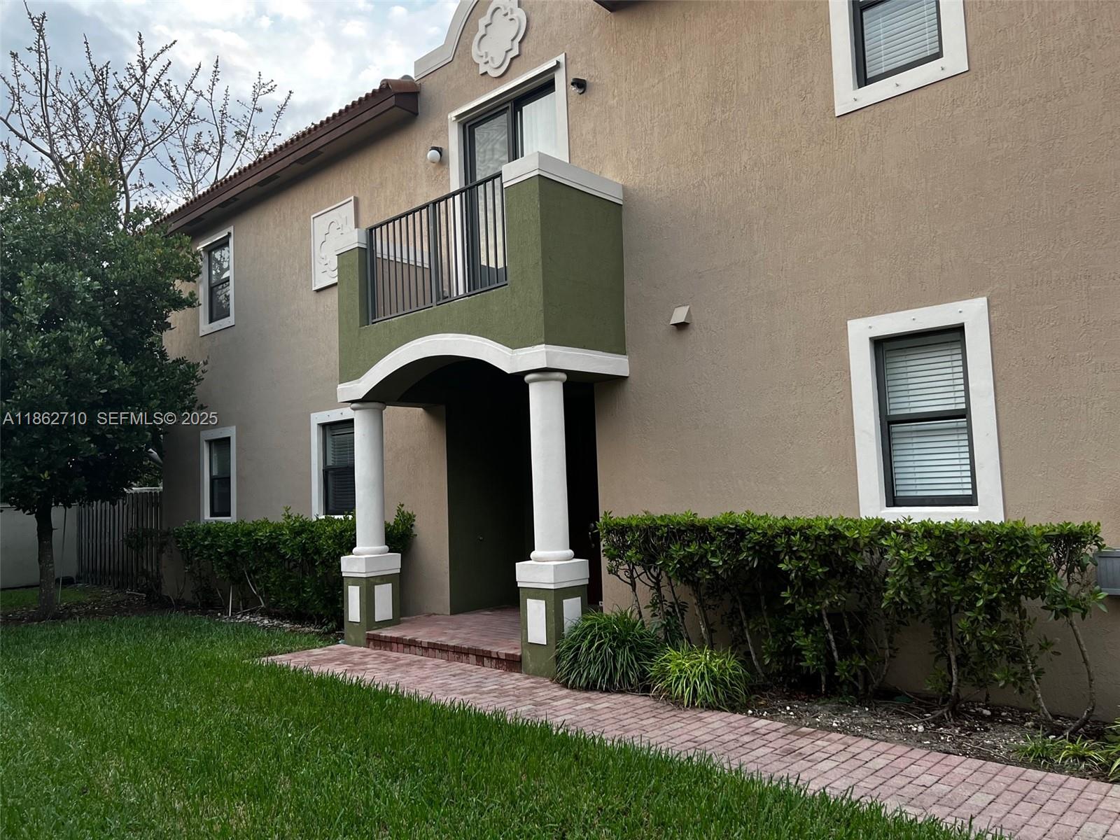 608 Northeast 33rd Terrace, Unit 608 Homestead, FL 33033 - Photo 24 of 35 a front view of a house with garden