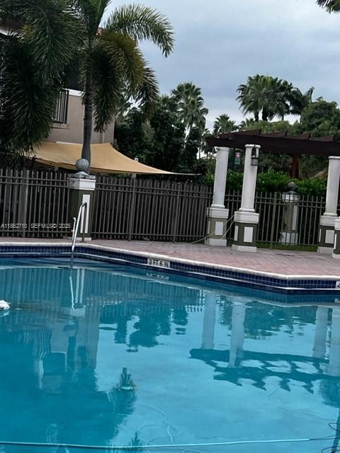 608 Northeast 33rd Terrace, Unit 608 Homestead, FL 33033 - Photo 30 of 35 a view of a swimming pool with a patio