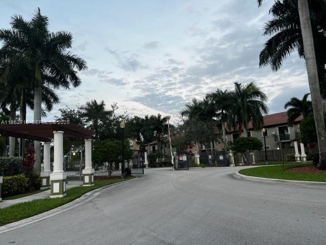 608 Northeast 33rd Terrace, Unit 608 Homestead, FL 33033 - Photo 34 of 35 a view of a street with a building and trees in the background