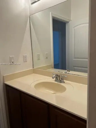 a bathroom with a sink vanity and a mirror