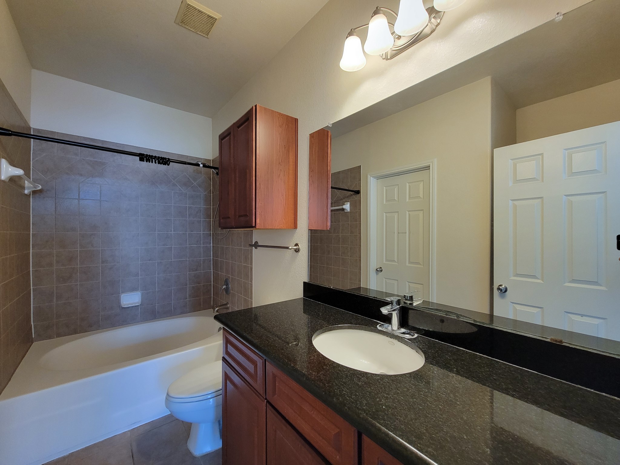 9200 Westheimer Road, Unit 305 Houston, TX 77063 - Photo 18 of 32 a bathroom with a granite countertop sink and a bathtub