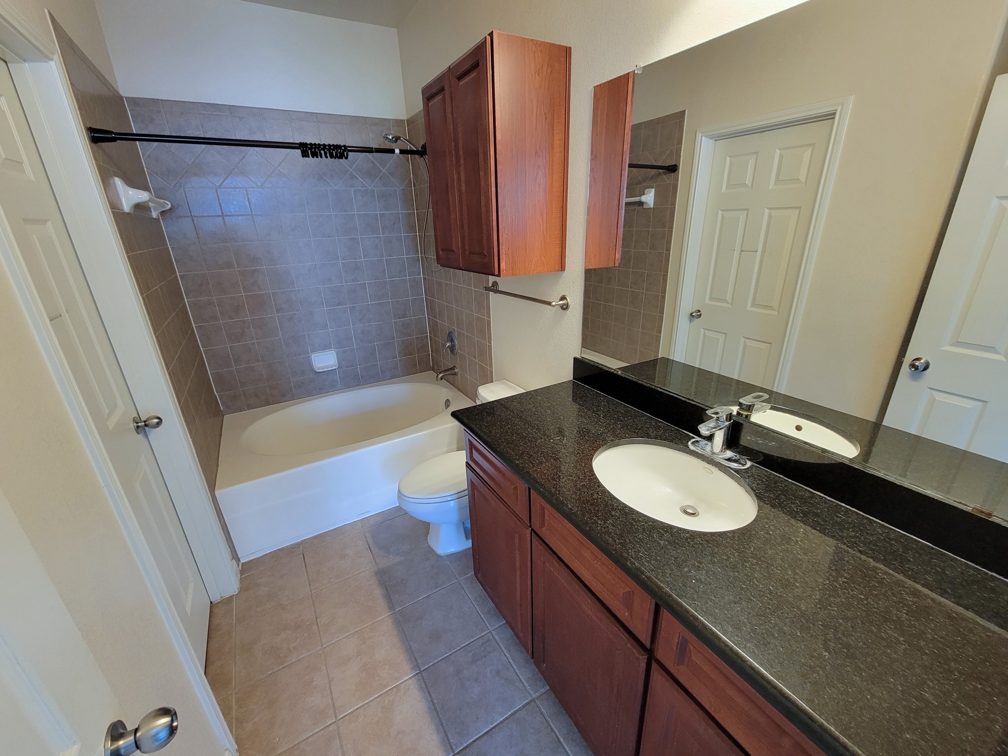 9200 Westheimer Road, Unit 305 Houston, TX 77063 - Photo 19 of 32 a bathroom with a granite countertop sink toilet and shower