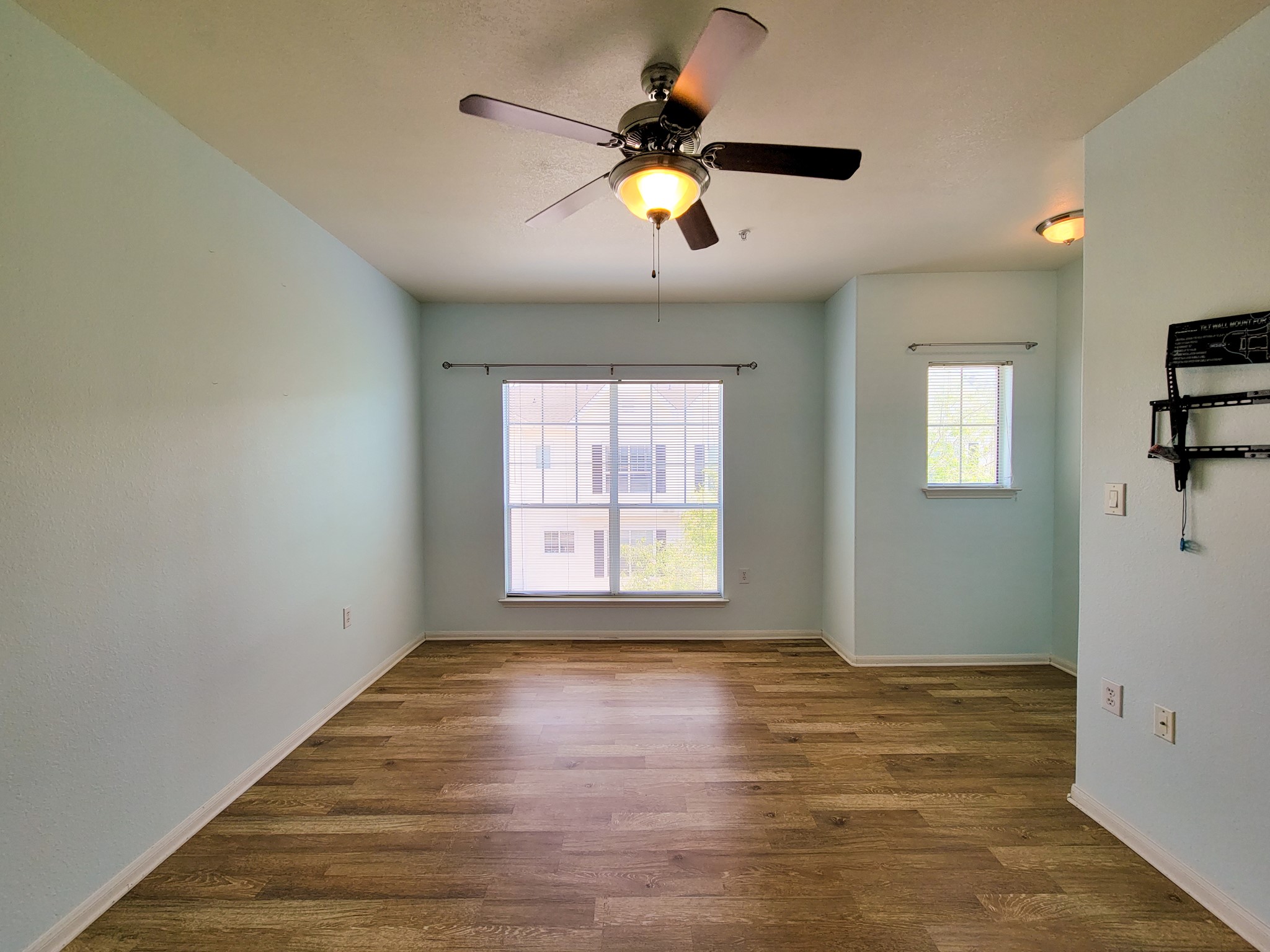 9200 Westheimer Road, Unit 305 Houston, TX 77063 - Photo 20 of 32 a view of an empty room with window and wooden floor