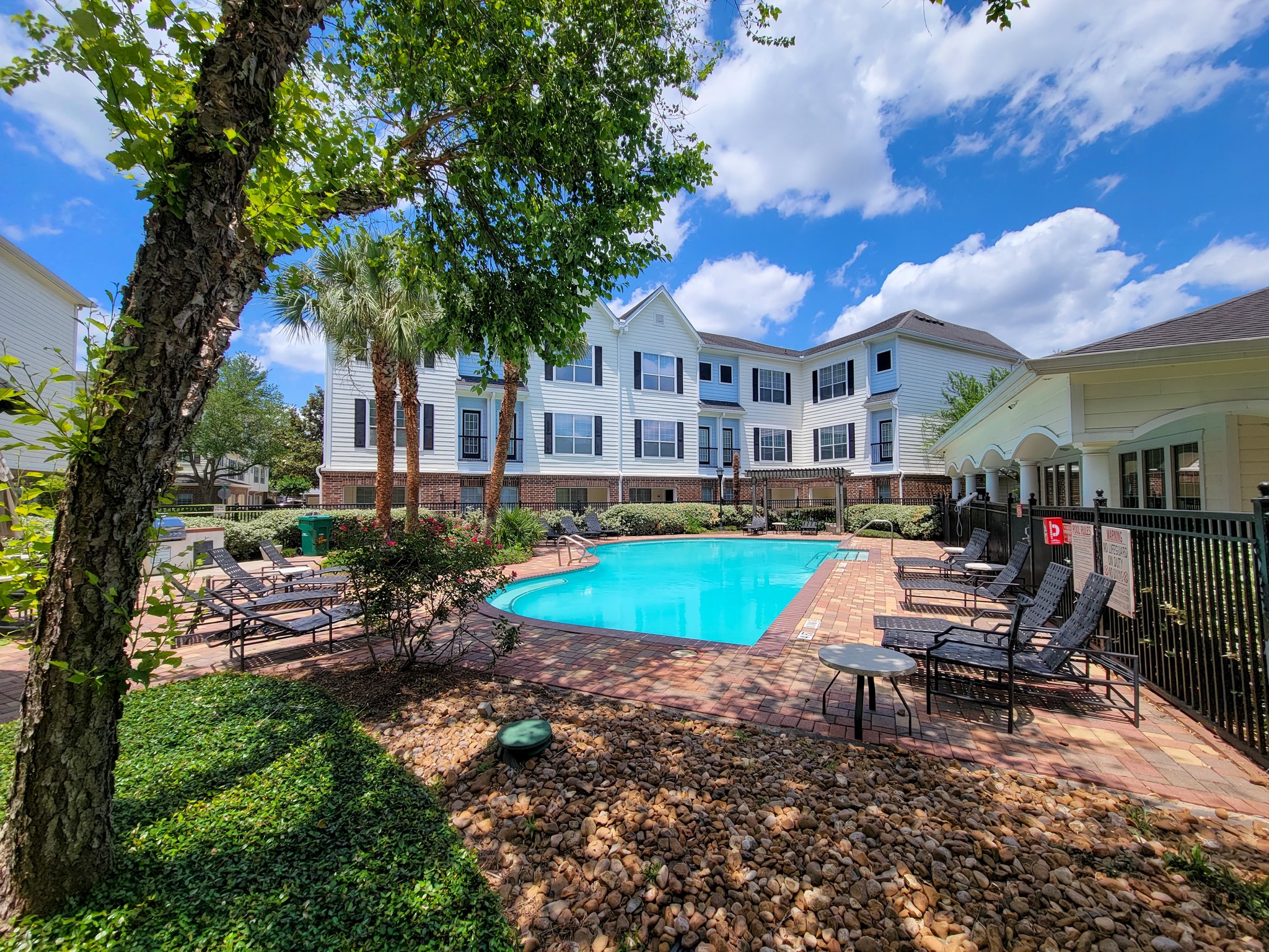 9200 Westheimer Road, Unit 305 Houston, TX 77063 - Photo 27 of 32 a view of a house with a yard patio and swimming pool