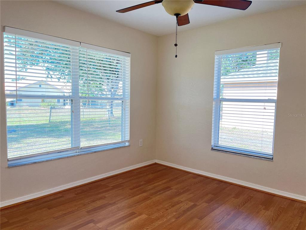 117 Angol Street Punta Gorda, FL 33983 - Photo 26 of 47 a view of an empty room with wooden floor and a window