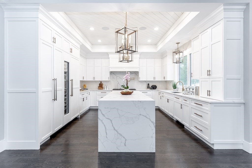 35 Wayne Road Newton, MA 02459 - Photo 12 of 33 a kitchen with stainless steel appliances kitchen island granite countertop a sink a refrigerator and white cabinets