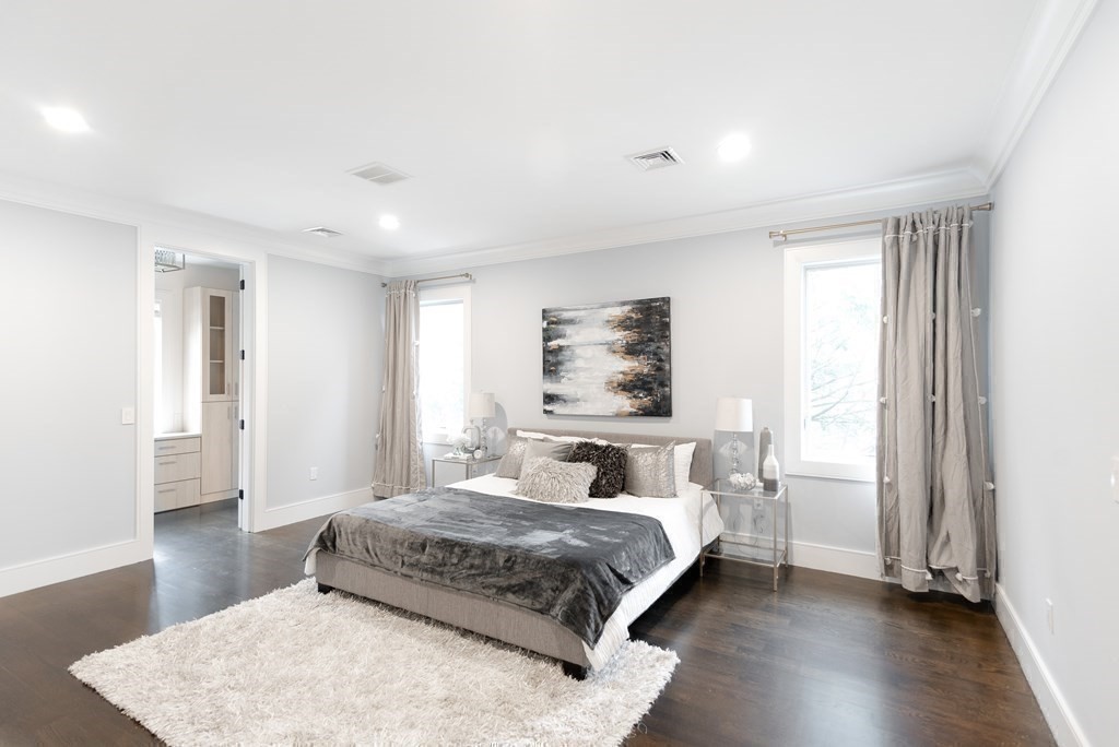 35 Wayne Road Newton, MA 02459 - Photo 20 of 33 a bedroom with a large bed and a wooden floor