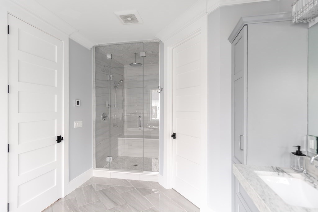 35 Wayne Road Newton, MA 02459 - Photo 23 of 33 a bathroom with a granite countertop sink a shower and a mirror