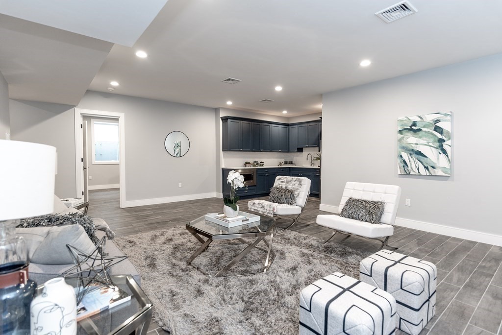 35 Wayne Road Newton, MA 02459 - Photo 27 of 33 a living room with furniture a couch and a fireplace