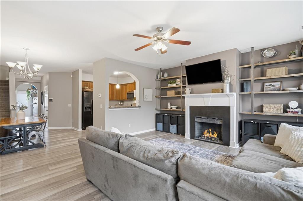 615 Myers Gate Road Ball Ground, GA 30107 - Photo 3 of 43 a living room with furniture a fireplace and a flat screen tv