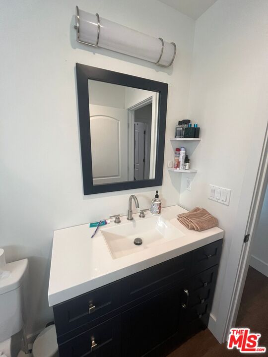 8302 Capps Avenue Northridge, CA 91324 - Photo 14 of 16 a bathroom with a toilet sink and mirror