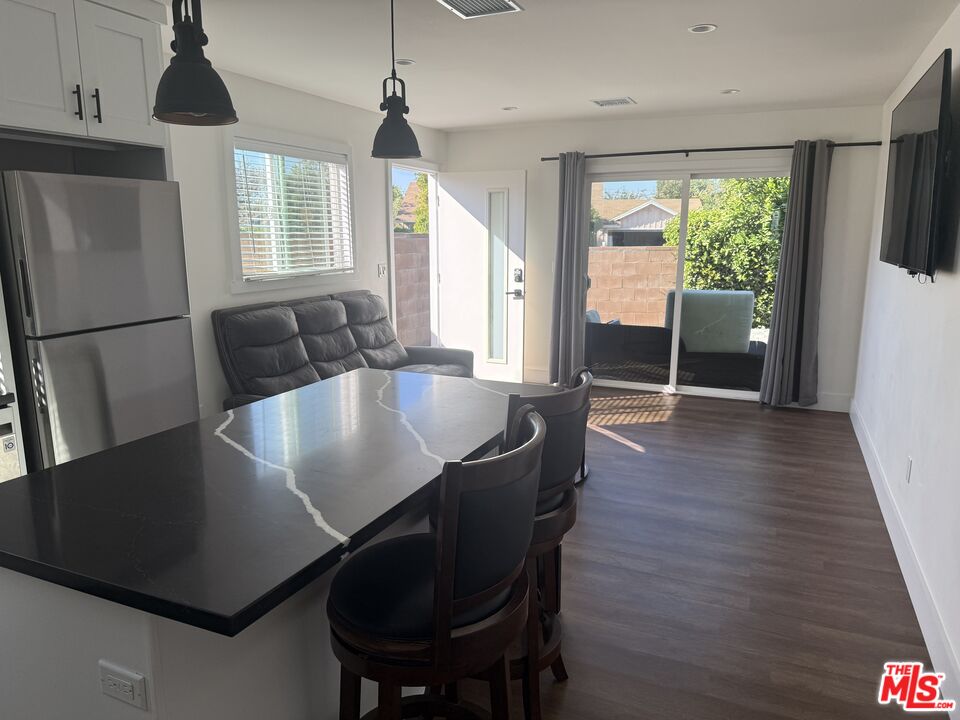 8302 Capps Avenue Northridge, CA 91324 - Photo 2 of 16 a view of a dining room with furniture window and wooden floor