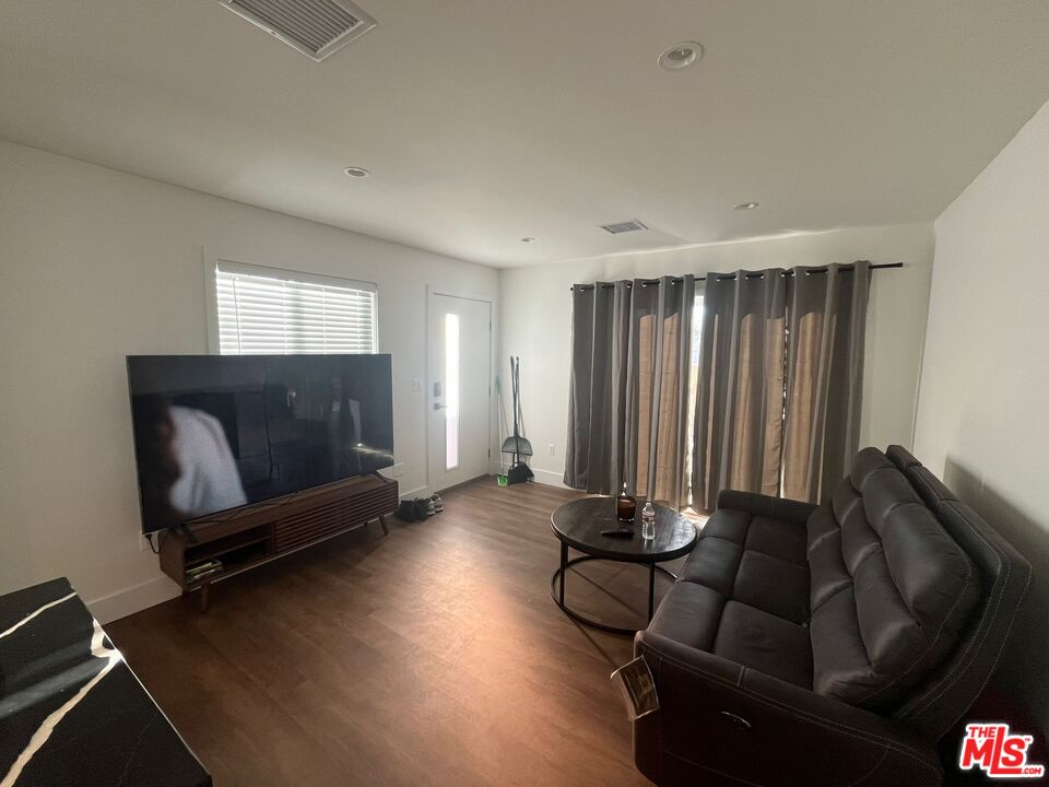 8302 Capps Avenue Northridge, CA 91324 - Photo 6 of 16 a living room with furniture and a flat screen tv