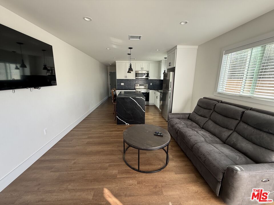8302 Capps Avenue Northridge, CA 91324 - Photo 7 of 16 a living room with furniture and a flat screen tv