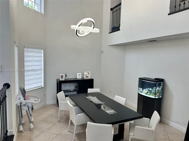 a view of a dining room with furniture and chandelier