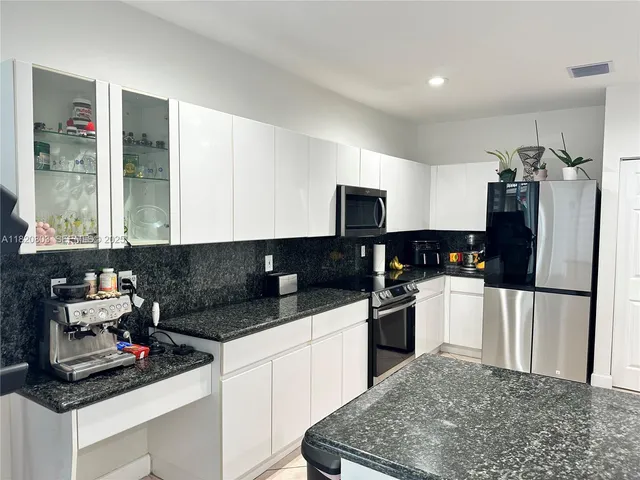 a kitchen with a sink stove and refrigerator
