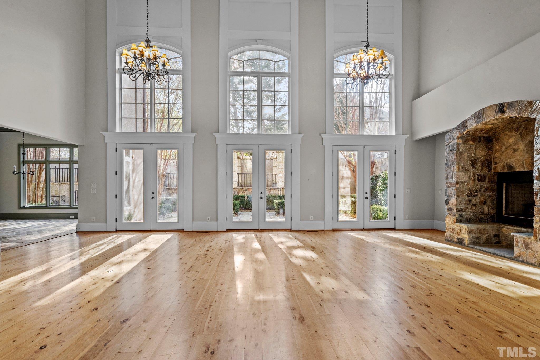 12501 Village Springs Road Raleigh, NC 27614 - Photo 4 of 93 a view of an empty room with wooden floor and a window