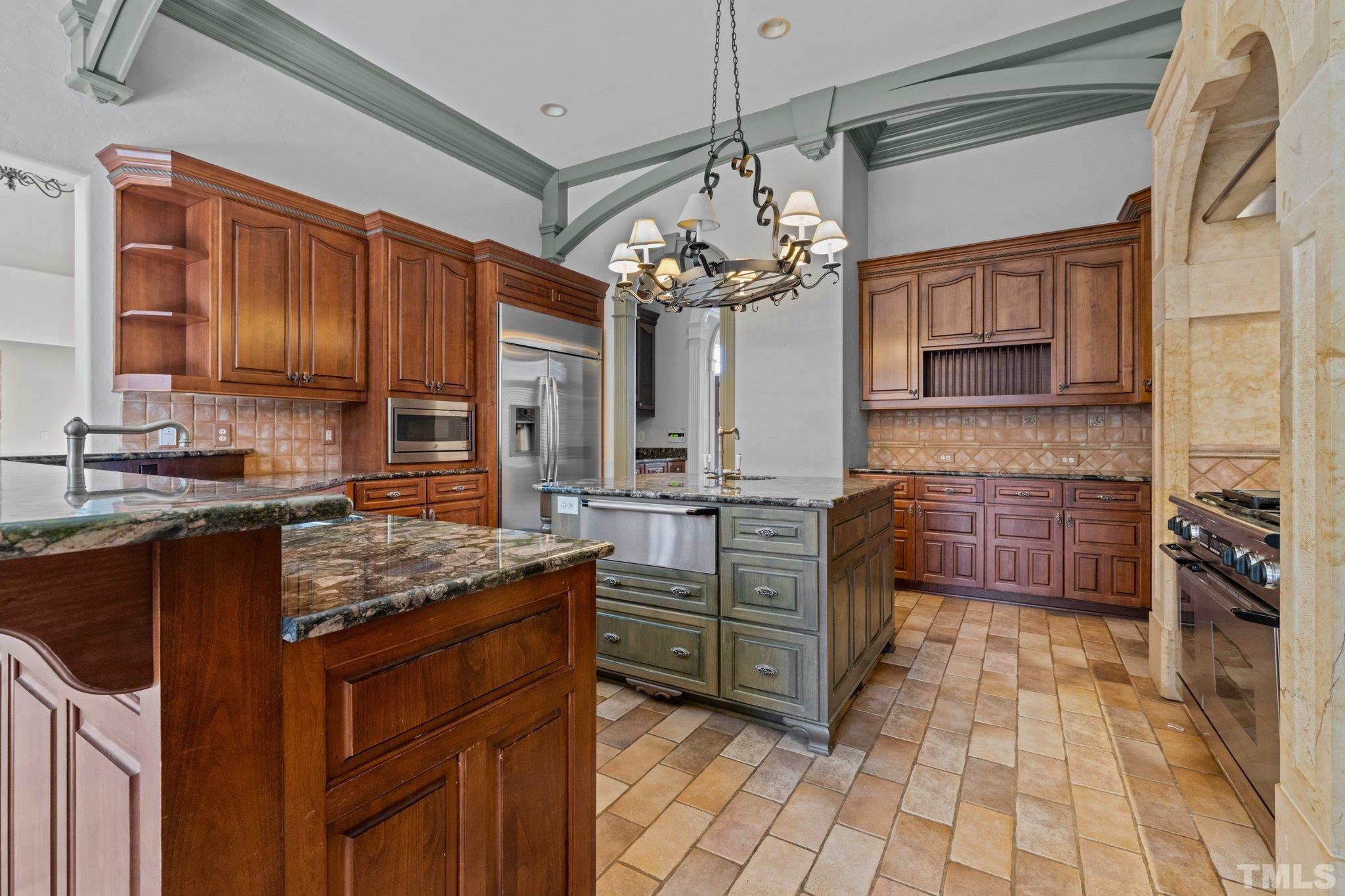 12501 Village Springs Road Raleigh, NC 27614 - Photo 50 of 93 a kitchen with stainless steel appliances granite countertop a stove sink and cabinets
