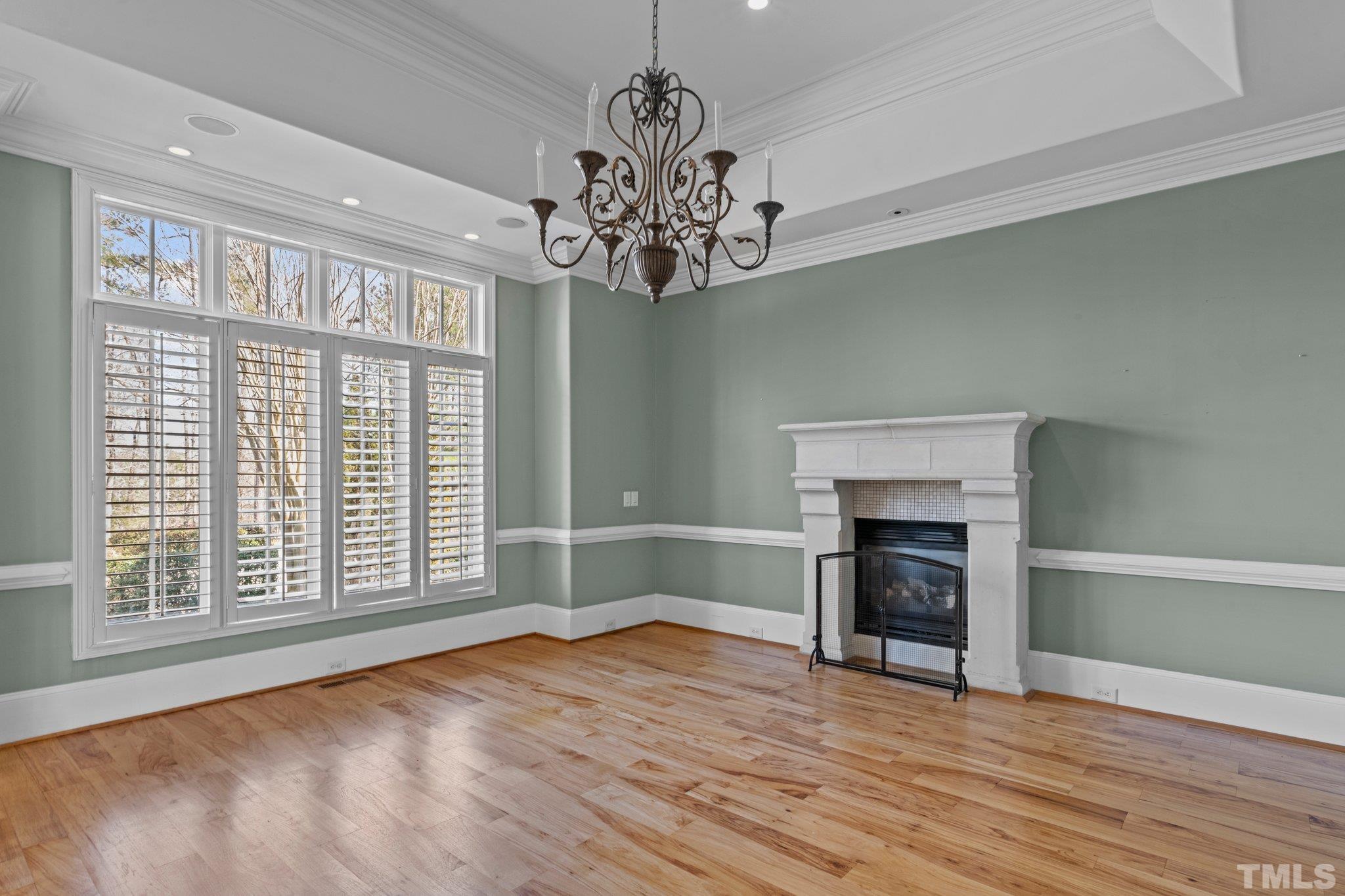 12501 Village Springs Road Raleigh, NC 27614 - Photo 54 of 93 a view of an empty room with a fireplace and a window