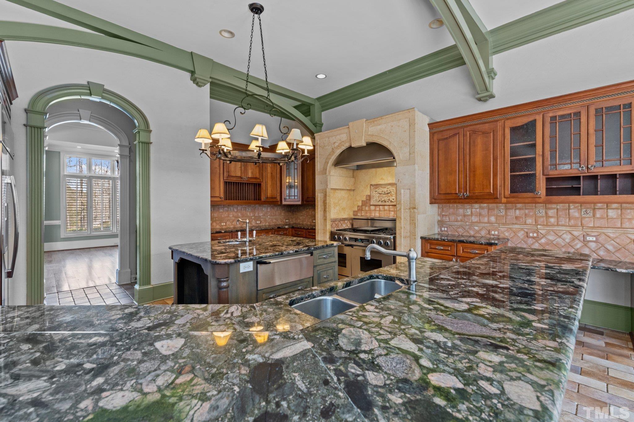 12501 Village Springs Road Raleigh, NC 27614 - Photo 60 of 93 a view of a kitchen with a sink and a refrigerator