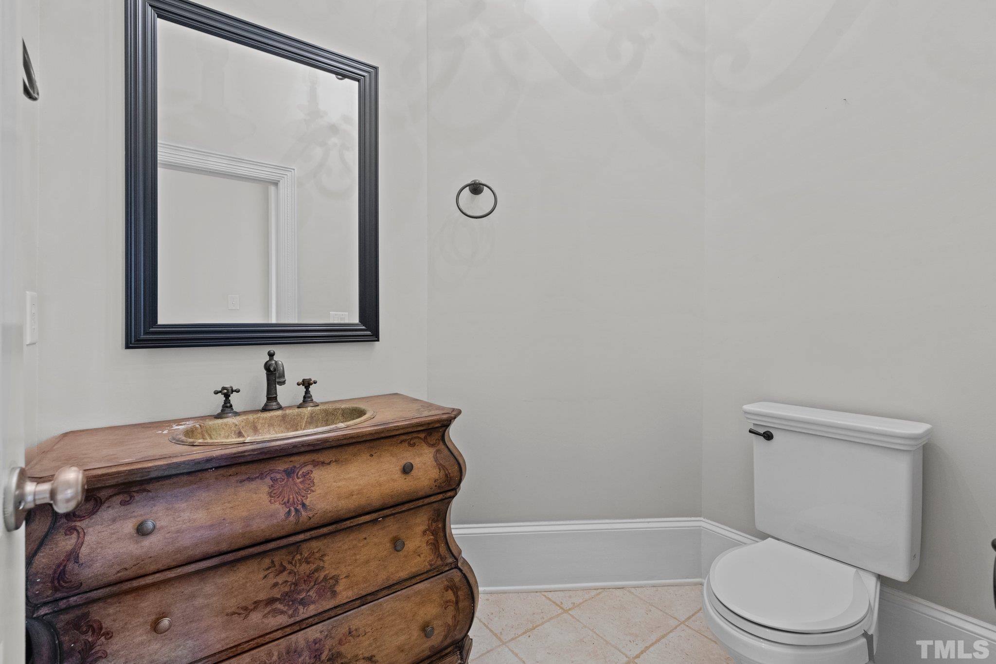 12501 Village Springs Road Raleigh, NC 27614 - Photo 61 of 93 a bathroom with a toilet sink vanity and mirror