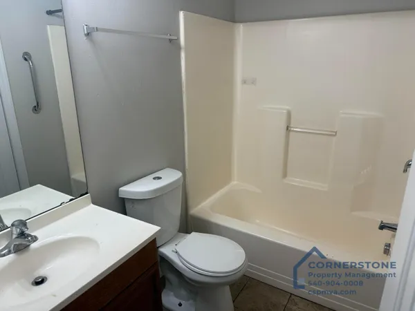 a white toilet sitting next to a bathroom sink