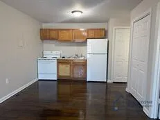 a kitchen with stainless steel appliances a refrigerator and a stove top oven