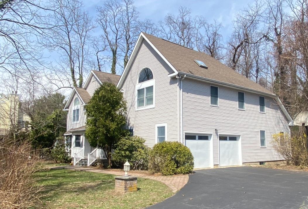 155 Lower Sheep Pasture Road Setauket, NY 11733 - Photo 2 of 8 View of side of home featuring aphalt driveway, an attached garage, and a shingled roof